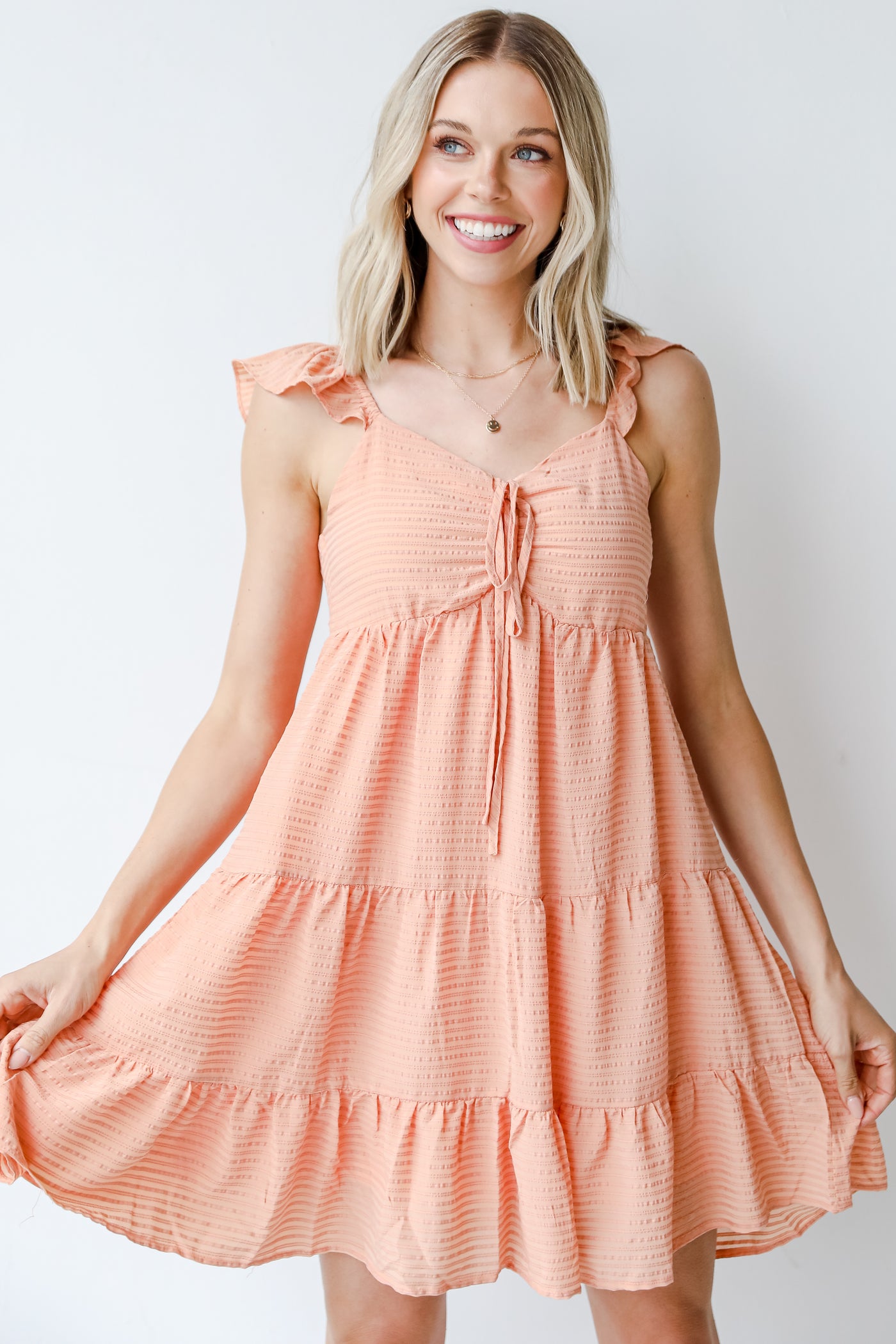 Tiered Mini Dress in coral on model