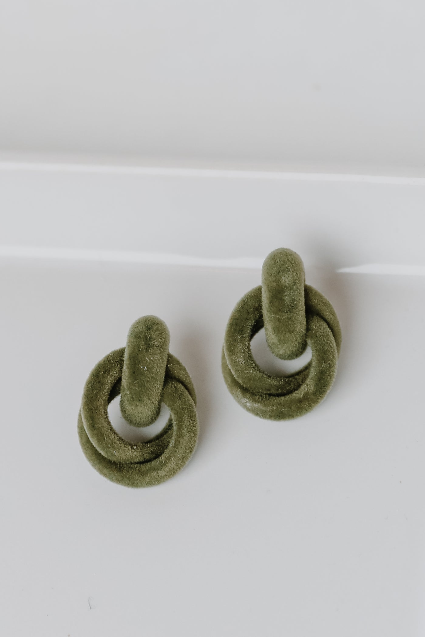 Velvet Circle Drop Earrings in olive flat lay