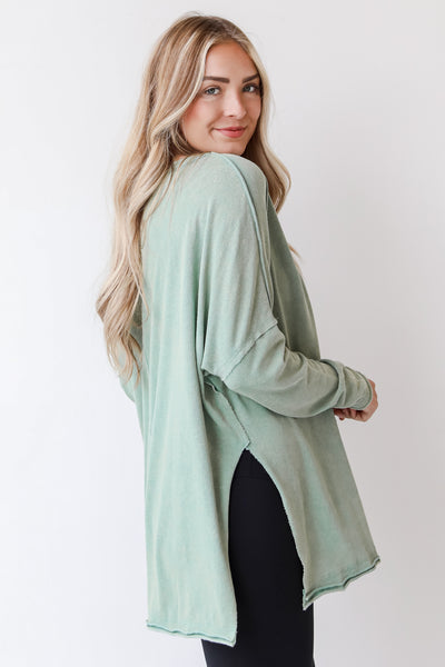 green knit top side view
