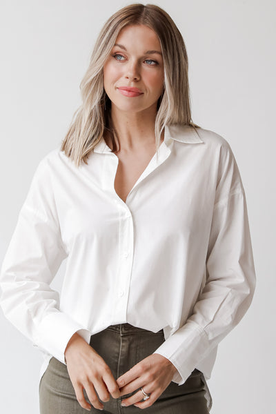 white button front blouse on model